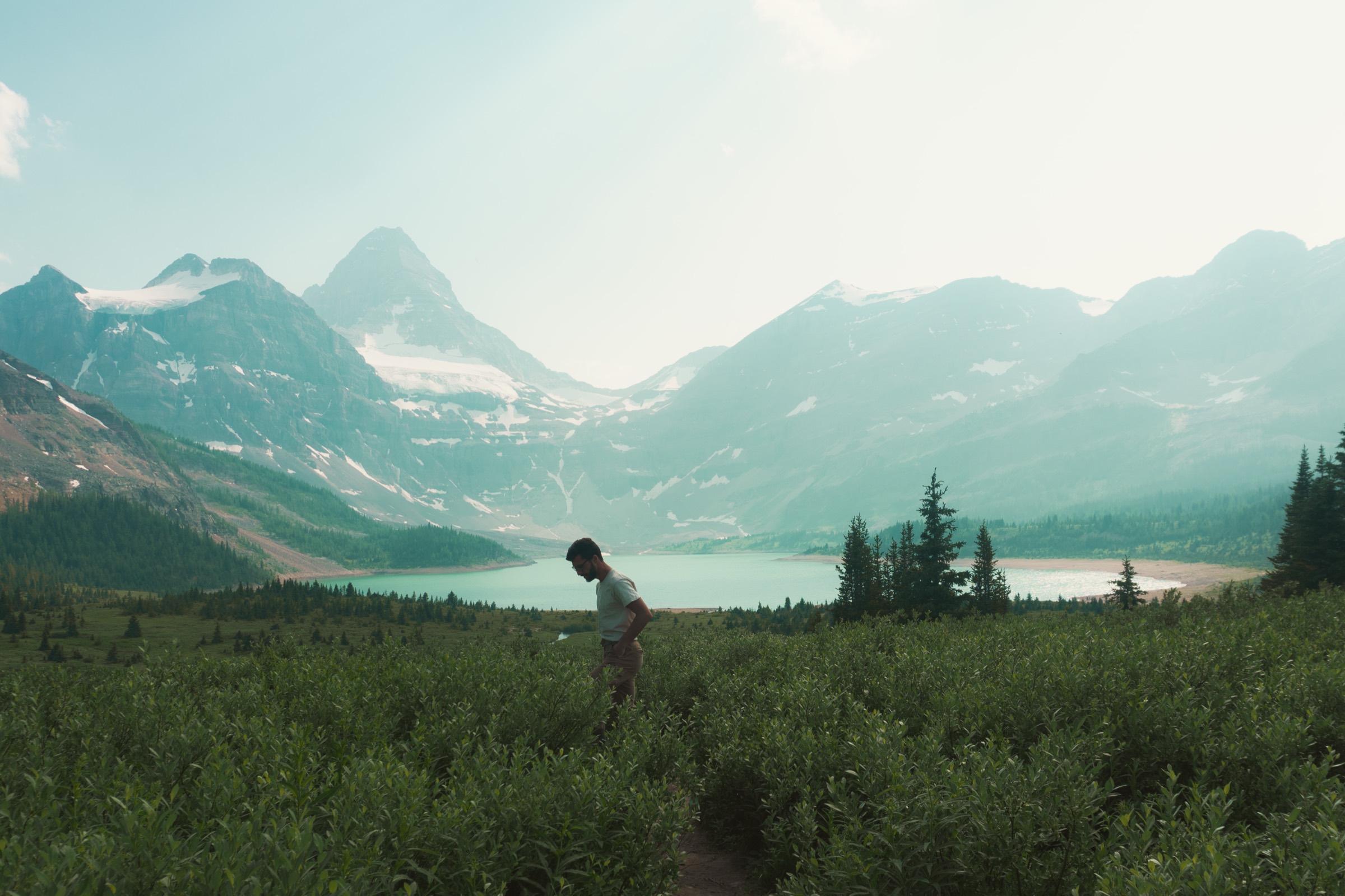 Banff photographer standing in the mountains above a lake
